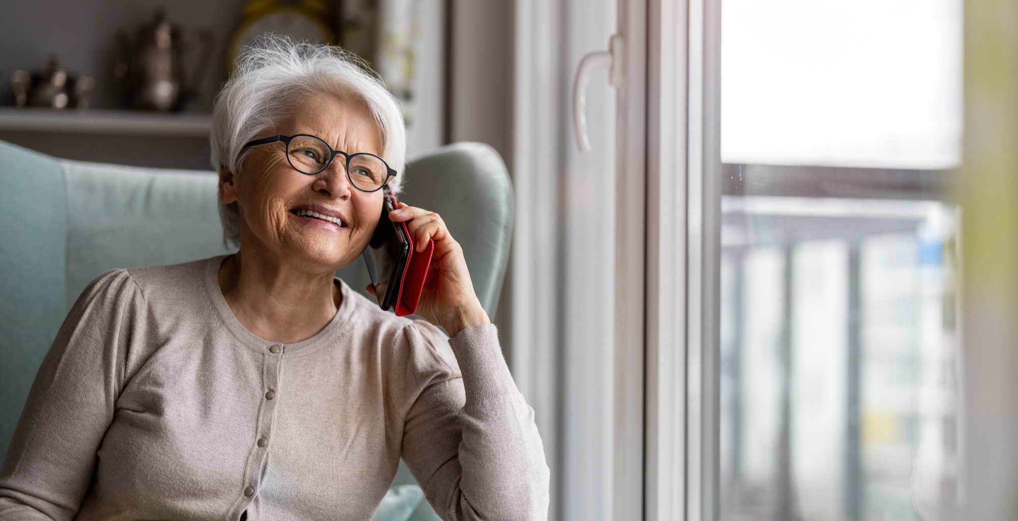 An image from Telefónica Tech showing an elderly couple hugging and smiling in a natural setting at sunset.